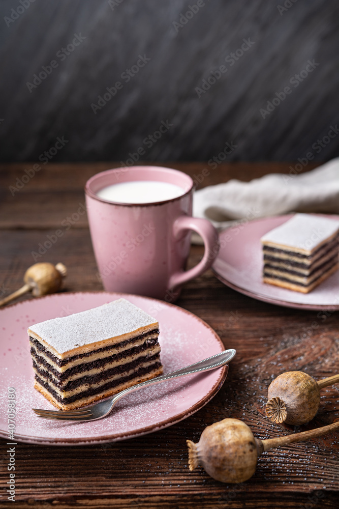 Layered poppy seed cake dusted with powdered sugar