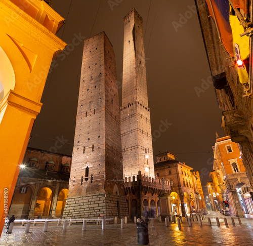 Bologna - The towers Torre della Garisenda and Torre della Asinelli and square Piazza della Mercanzia at night