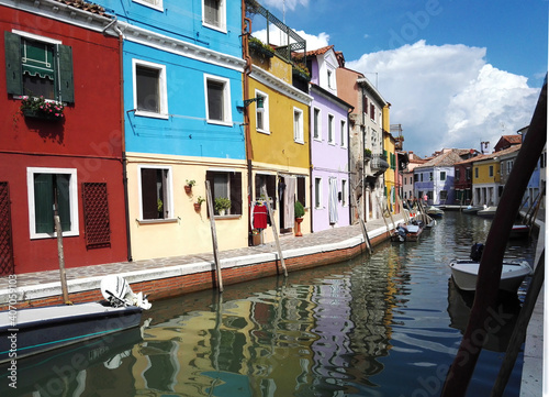 Obraz na płótnie Venice, Italy - September 03, 2018: Wide angle shot of canal in Murano burano along with italian building exterior architecture city against clouds w salonie