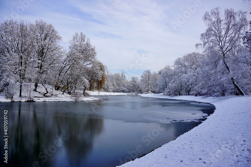 Amazing winter view of the pond. City park in winter scenery. Beautiful little pond in winter.