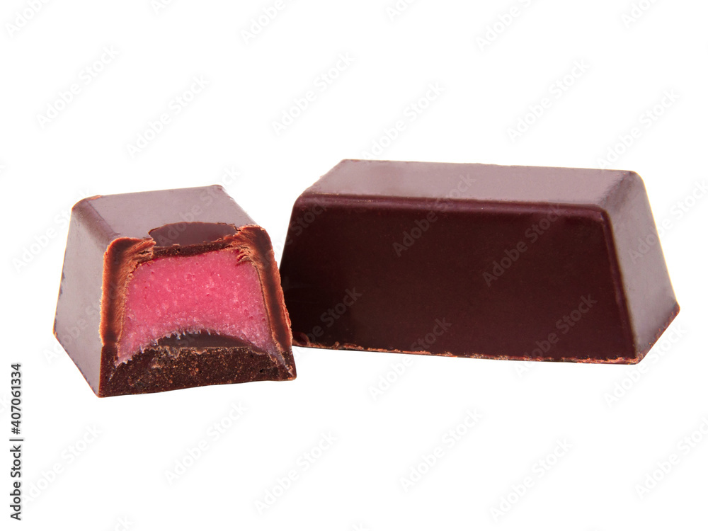 Chocolate sweets with pink strawberry filling praline isolated on the white Chocolate sweets with pink strawberry filling praline isolated on the white