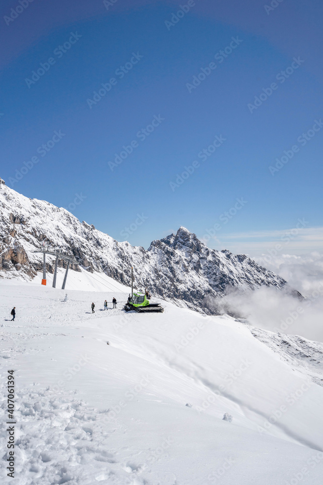 Zugspitze, Germany - Aug 5, 2020: Snow bulldozer below the summit at Sonnalpin