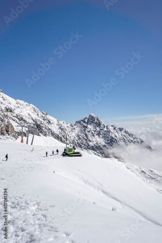 Zugspitze, Germany - Aug 5, 2020: Snow bulldozer below the summit at Sonnalpin