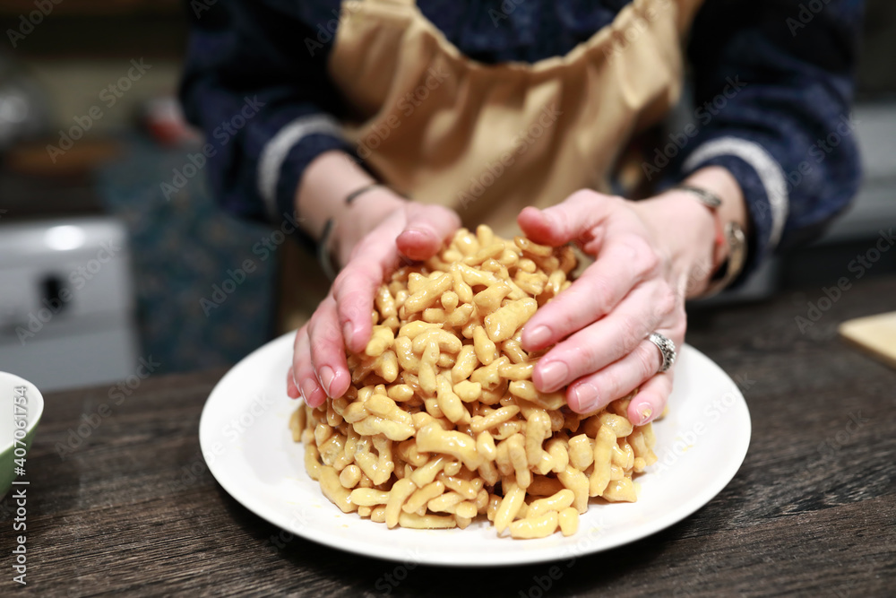 Person forms chak-chak on plate