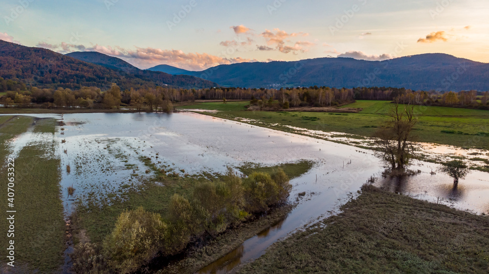 Aerial view of flooded fields at sunset.