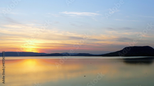 Sunset by lake Balaton in Hungary with volcanic hill Badacsony 