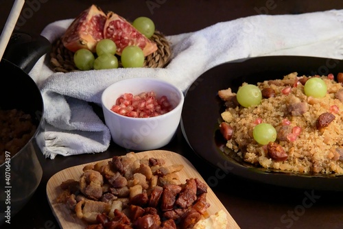 Food spanish crumbs with sausages, bacon, pomegranate and grapes