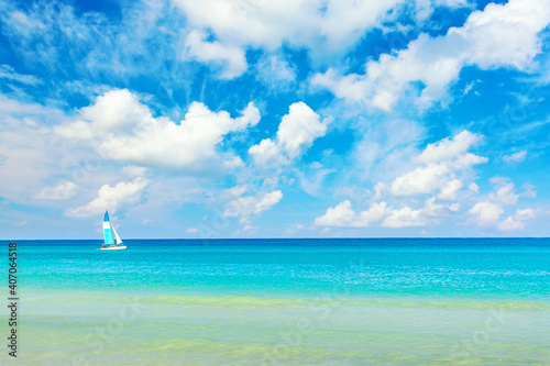 Idyllic romantic vacation background. Sailboat on a sunny day with turquoise water and blue sky in Varadero, Cuba.