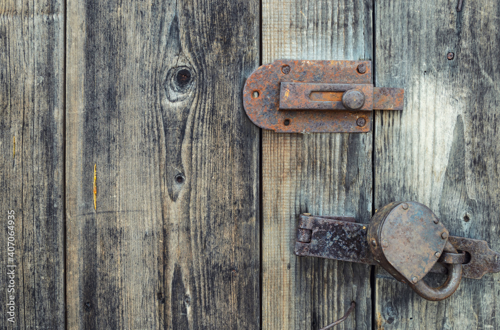 Old wooden door locked on padlock Old wooden door locked on padlock