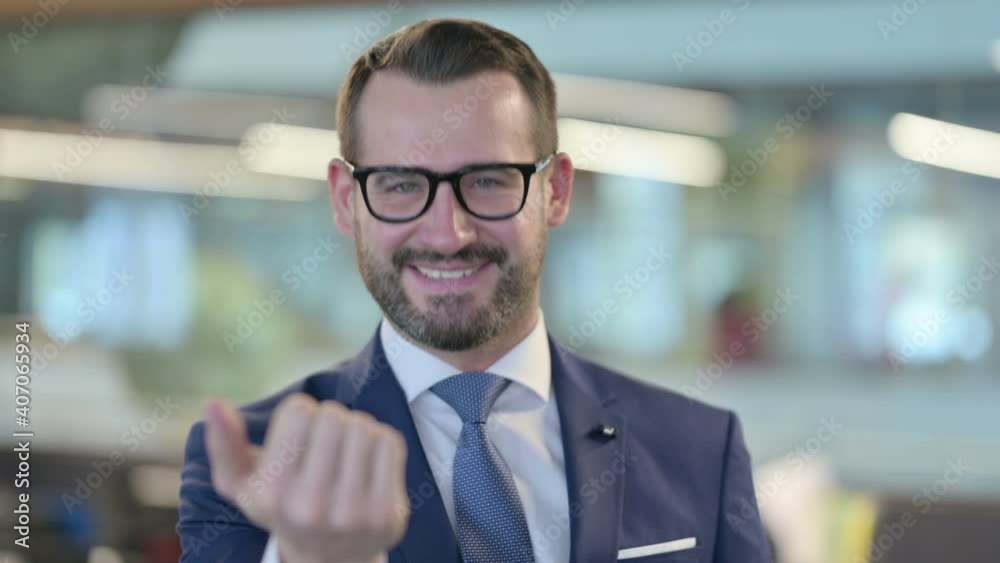 Portrait of Middle Aged Businessman Pointing at Camera, Inviting Portrait of Middle Aged Businessman Pointing at Camera, Inviting