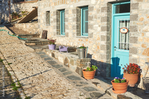 Fototapeta Naklejka Na Ścianę i Meble -  traditional house with gray stone and blue windows in the Zagori area, Greece
