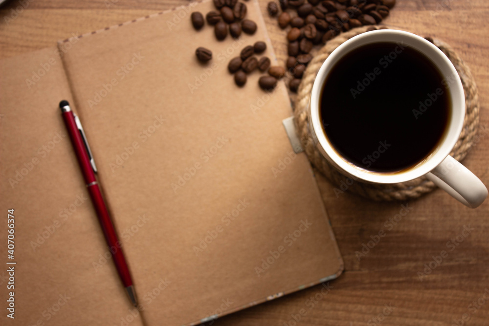 cup of coffee, coffee beans and notebook on wooden table in workplace, selective focus. For to do list background, top view. copy space for your text cup of coffee, coffee beans and notebook on wooden table in workplace, selective focus. For to do list background, top view. copy space for your text