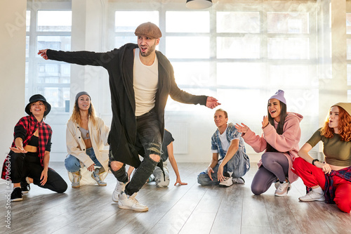 Photography male hip hop artist break dancer dancing in the studio, caucasian man in stylish