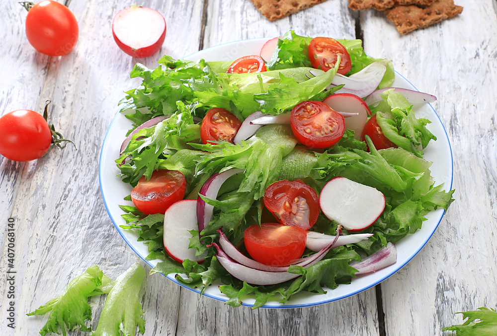 Vegetable salad with cherry tomatoes, onions, radishes and fresh arugula, Healthy natural breakfast for a dietary lifestyle, detox diet Balanced food without cholesterol and GMO, selective focus,