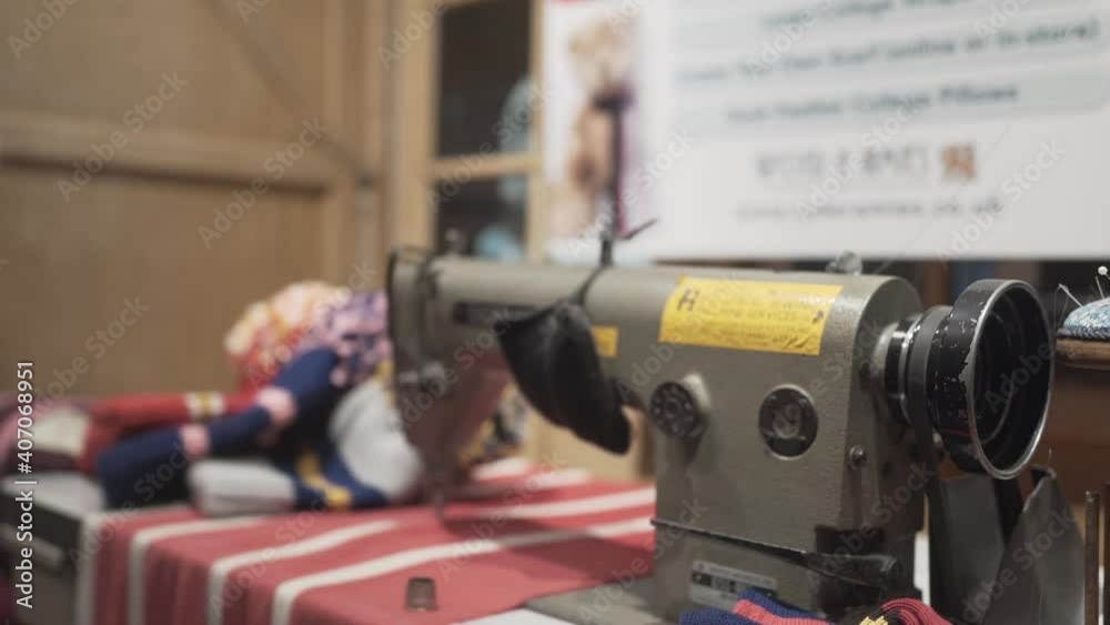 Classic sewing machine and striped wool clothes on a table. Cambridge city university store england Classic sewing machine and striped wool clothes on a table. Cambridge city university store england