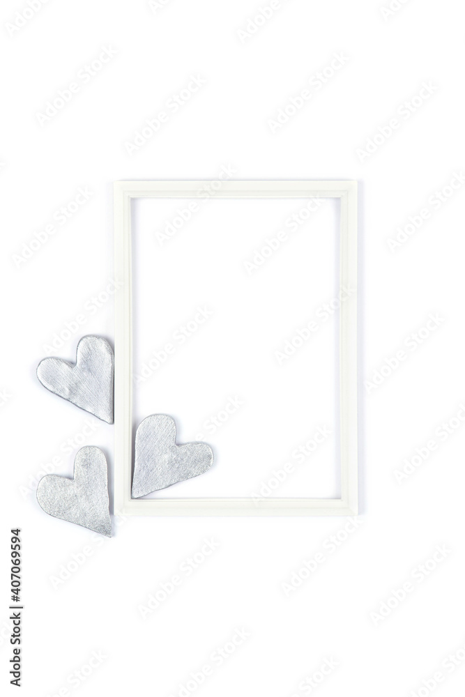 Top view of white blank photo frame with silver gray decorative hearts isolated on white background. Valentines day love concept. Mock up.Copy space. Top view of white blank photo frame with silver gray decorative hearts isolated on white background. Valentines day love concept. Mock up.Copy space.