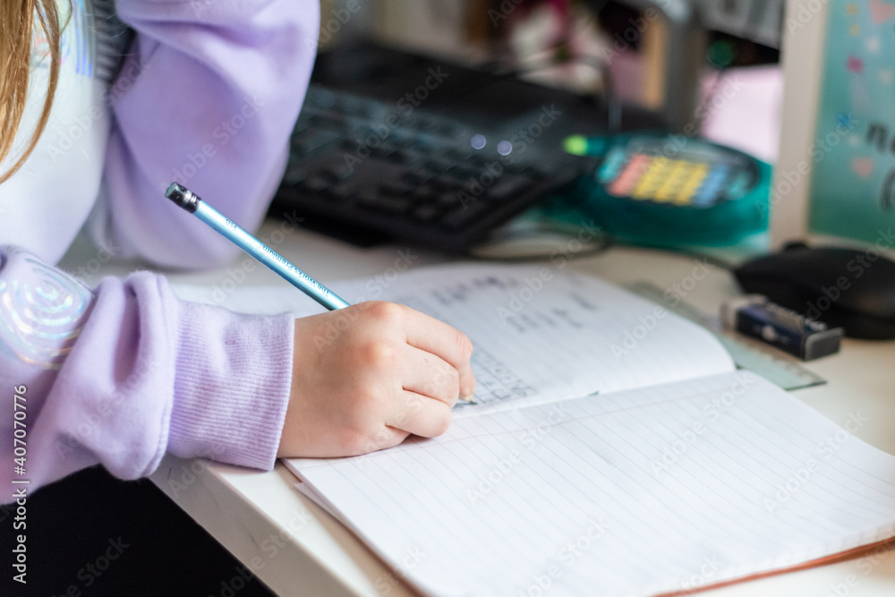 Young girl working at home during lockdown as children need to home school via online learning Young girl working at home during lockdown as children need to home school via online learning