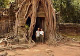 young couple exploring the archaeological site Angkor Wat in Cambodia