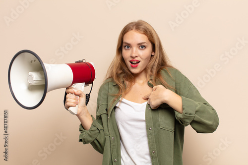 blonde woman looking shocked and surprised with mouth wide open, pointing to self photo