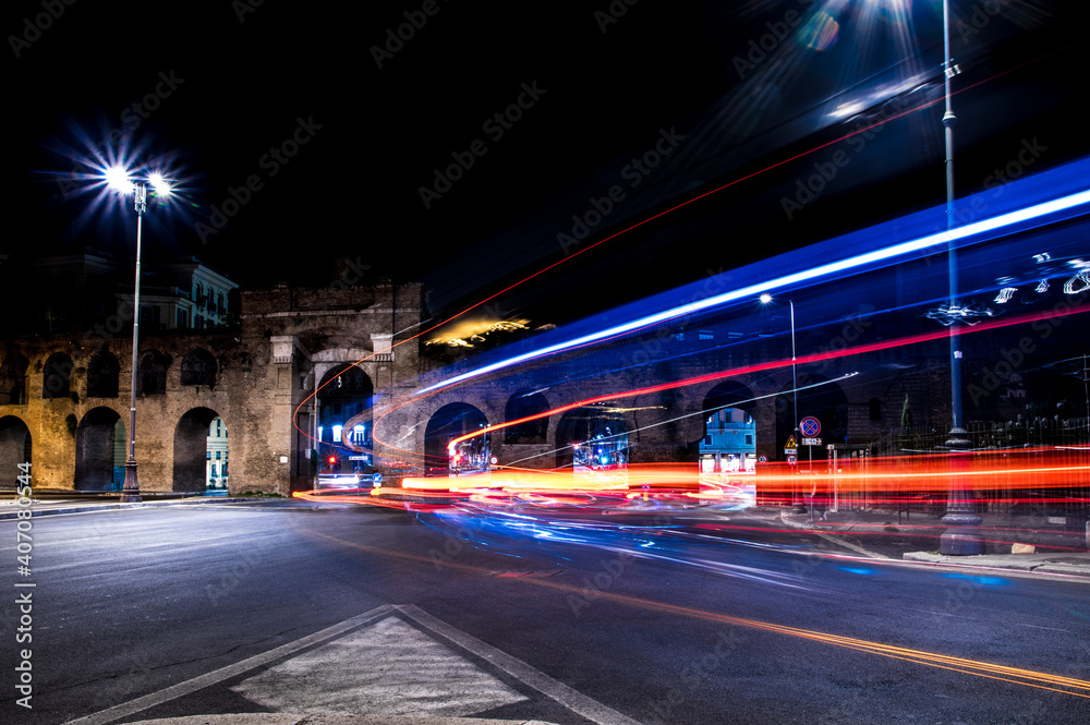 Porta san giovanni in notturna con effeti di luce prodotti dal traffico serale a Roma