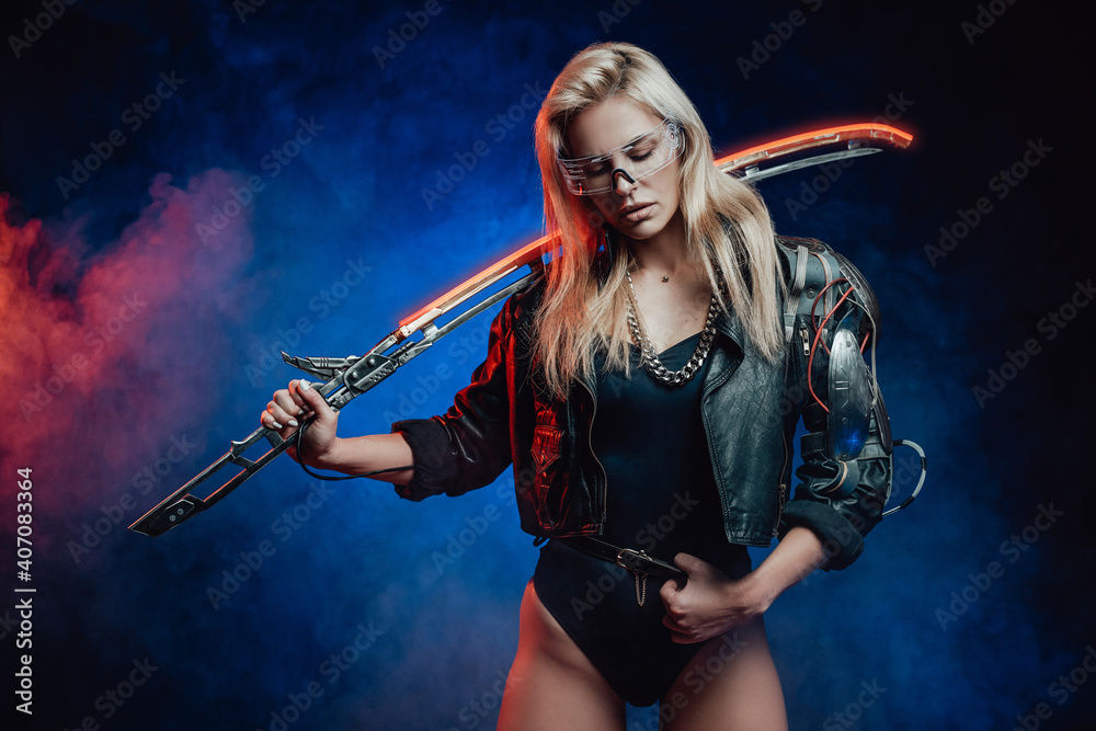 Attractive cyber woman in black leather jacket with sword poses in dark blue background.
