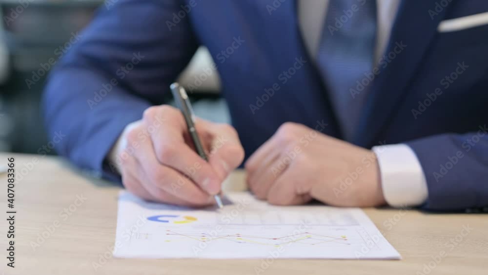 Close up of Hands of Businessman Writing on Paper Close up of Hands of Businessman Writing on Paper