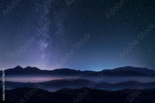 Mountains and milky way in the starry sky. © Артур Ничипоренко