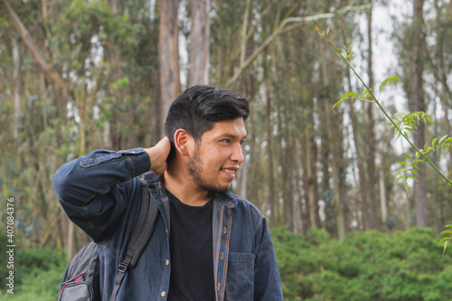Young man walking in the woods.