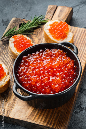 Canape toast with red caviar, on gray background