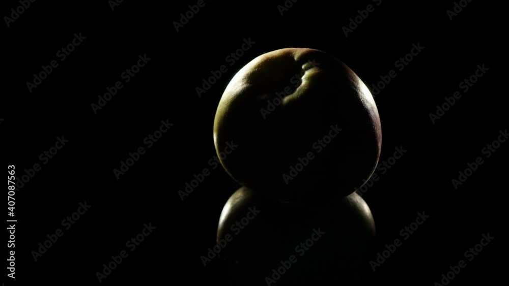 Gradually applying light to the apple. Formation of light and shadow on an apple Gradually applying light to the apple. Formation of light and shadow on an apple