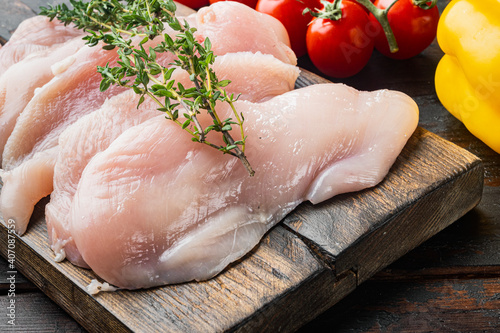 Raw chicken meat, on old dark wooden table background