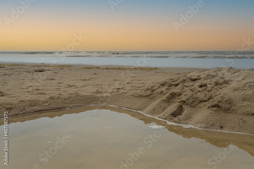 Seascape with a square hole with water in the foreground. Sea and sky in background. Vintage style photo