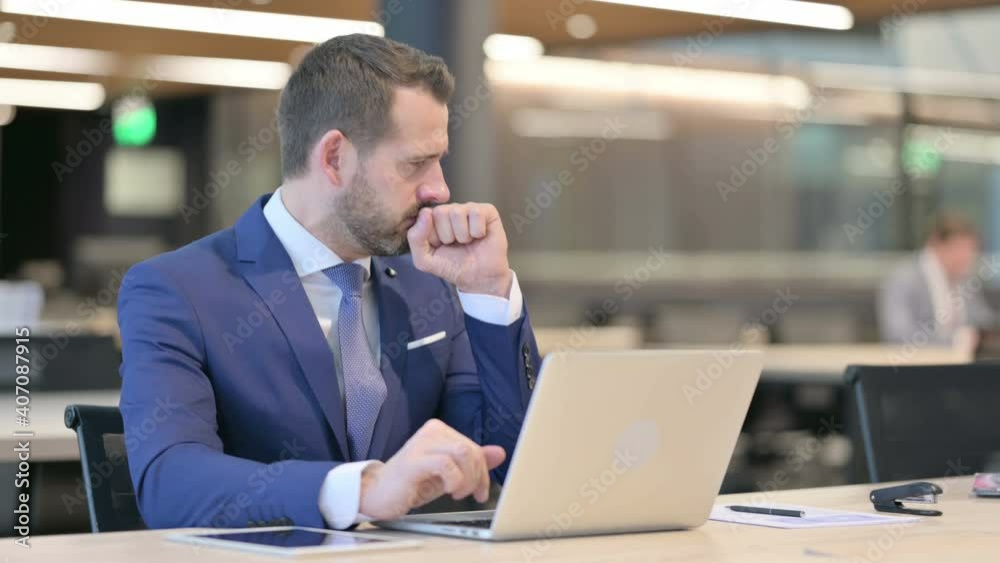 Middle Aged Businessman having Coughing At Work 