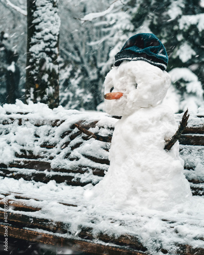 snowman in the park on the bench