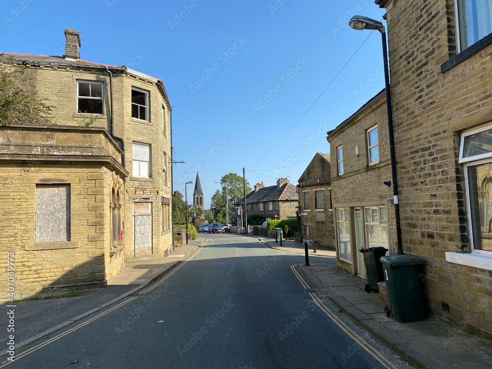 View along, Market Street, with Victorian buildings, and a blue sky in, Thornton, Bradford, UK