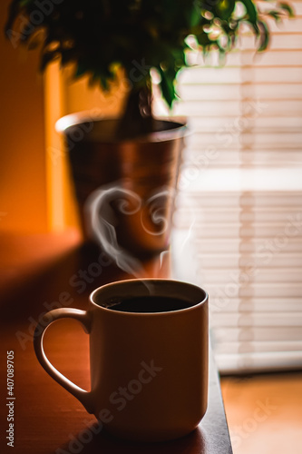 Beautiful cup of coffee in the morning with the heart shaped steam. Great start of the day!