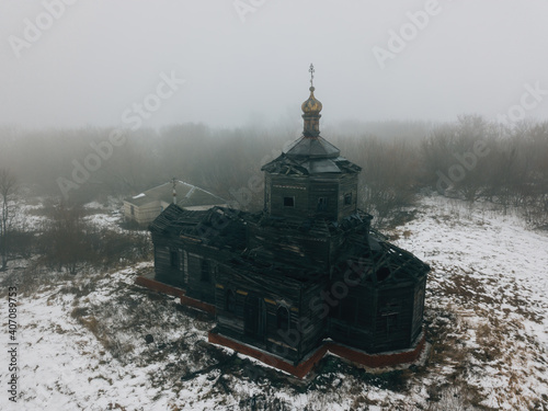 Old abandoned wooden ruined Russian church of Athanasius the Great in Lower Babino, Kursk region, aerial view photo