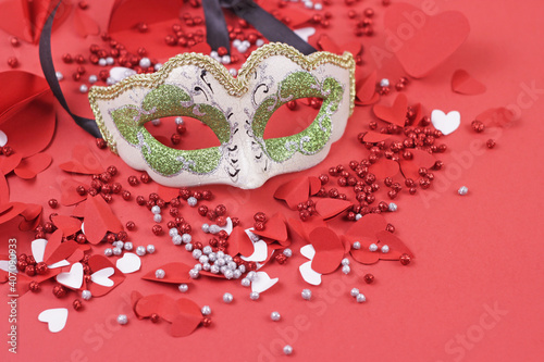 Carnival venice mask with hearts red background.