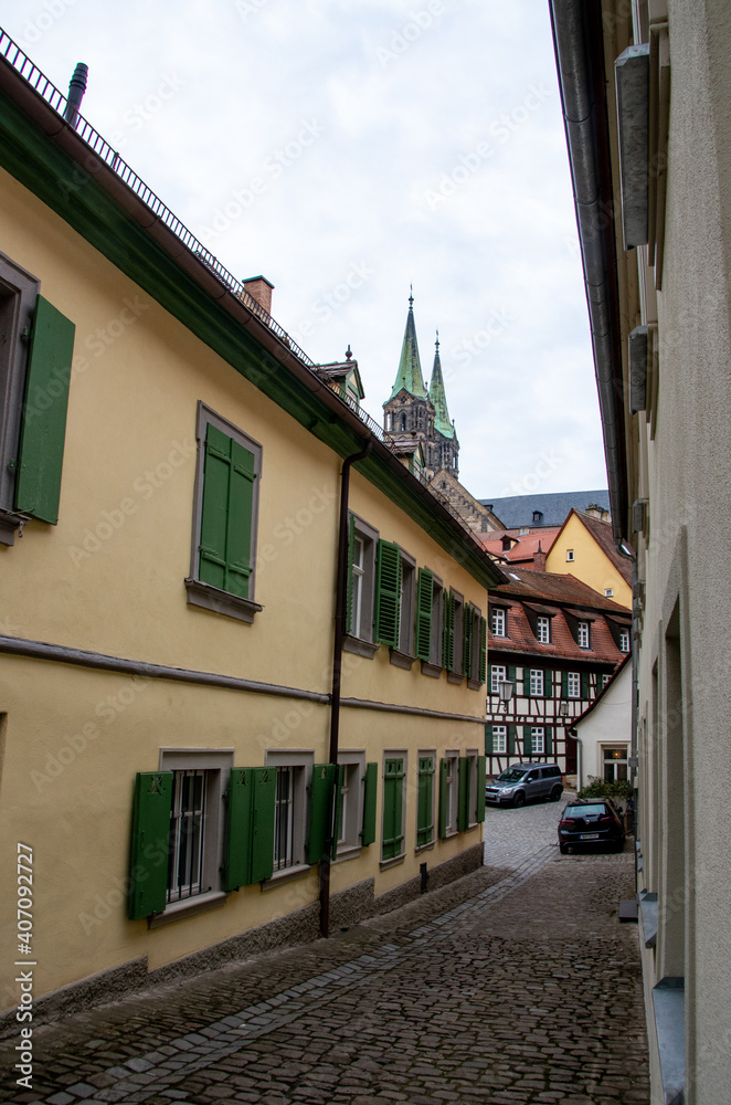 View into a narrow alley of the World Heritage city of Bamberg with the famous Bamberg Cathedral in the background. High quality photo