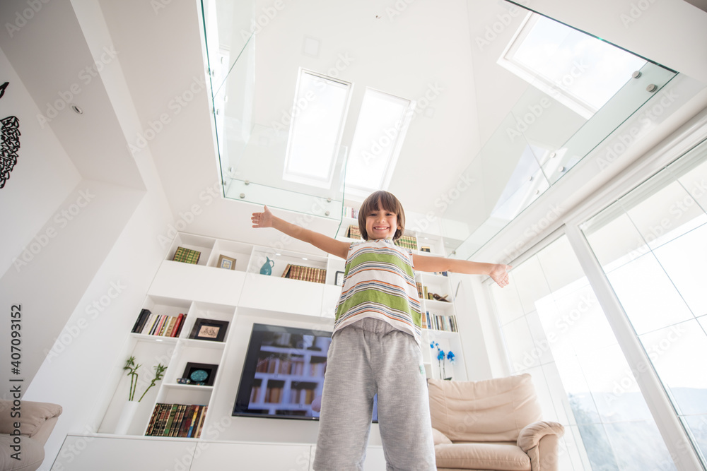 Happy kid at home with hands up Happy kid at home with hands up