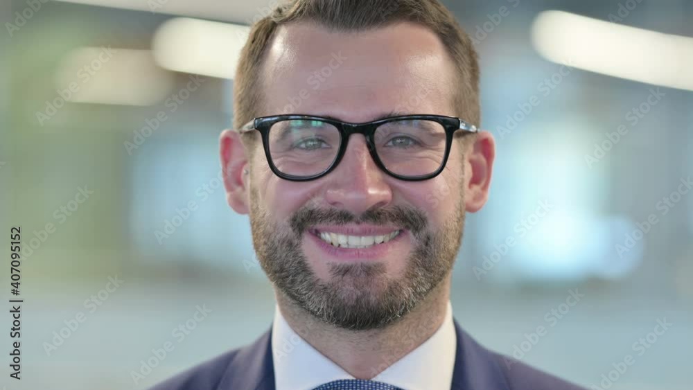 Close up of Middle Aged Businessman Smiling at Camera 