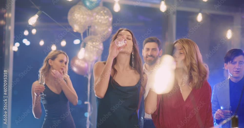 Caucasian beautiful young candid people dancing out together on corporate exciting party indoors. Attractive millennials. Adult event. Communication.