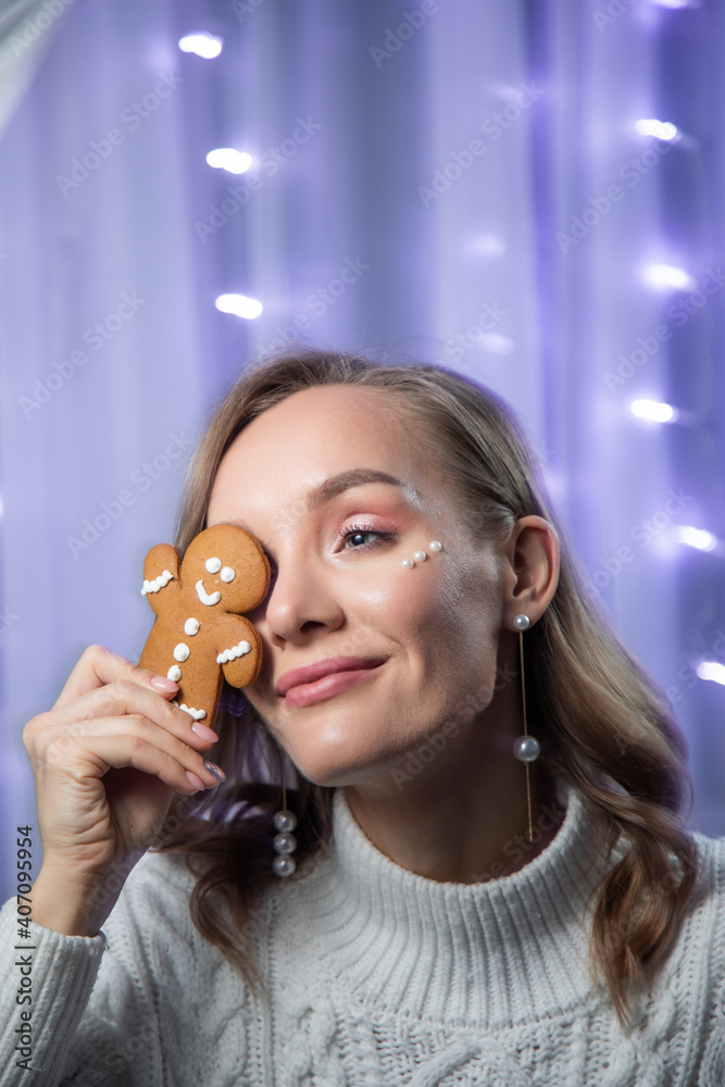 New Year's portrait of a girl with a gingerbread man in her hands