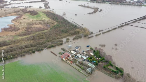 Aerial drone photo of the town of Allerton Bywater near Castleford in Leeds West Yorkshire showing the flooded fields from the River Aire on a rainy winters day during a large flood after a storm. photo