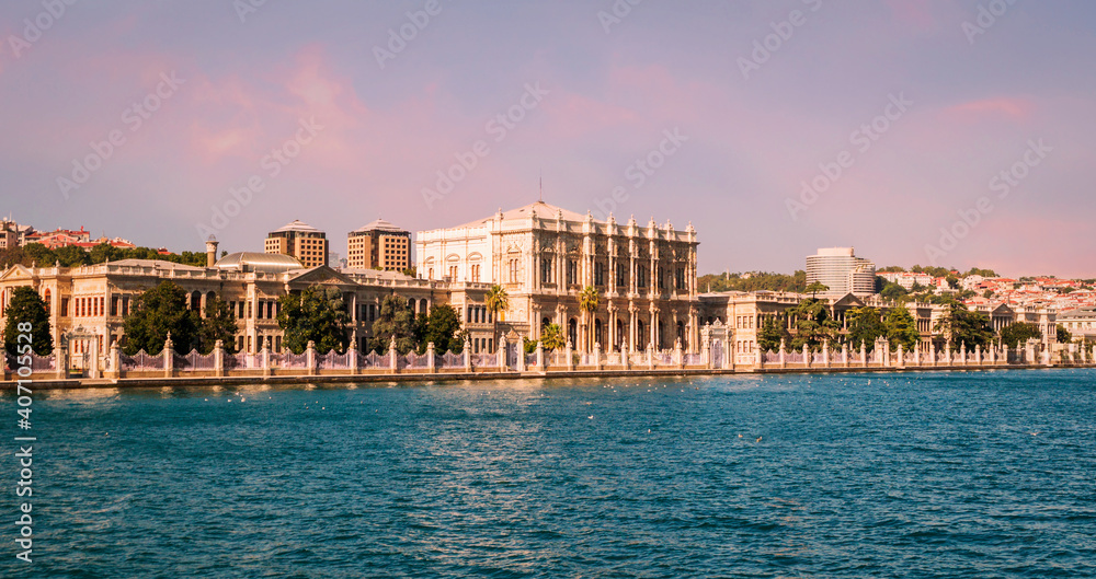 Sunset view on the bank of Bosporus Strait with glamorous Dolmabahce Palace, a museum in ornate Ottoman sultan palace in Besiktas district of Istanbul