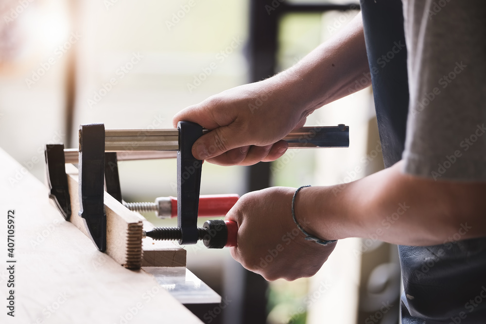 Woodworking operators are decorating pieces of wood to assemble and build wooden tables for customers
