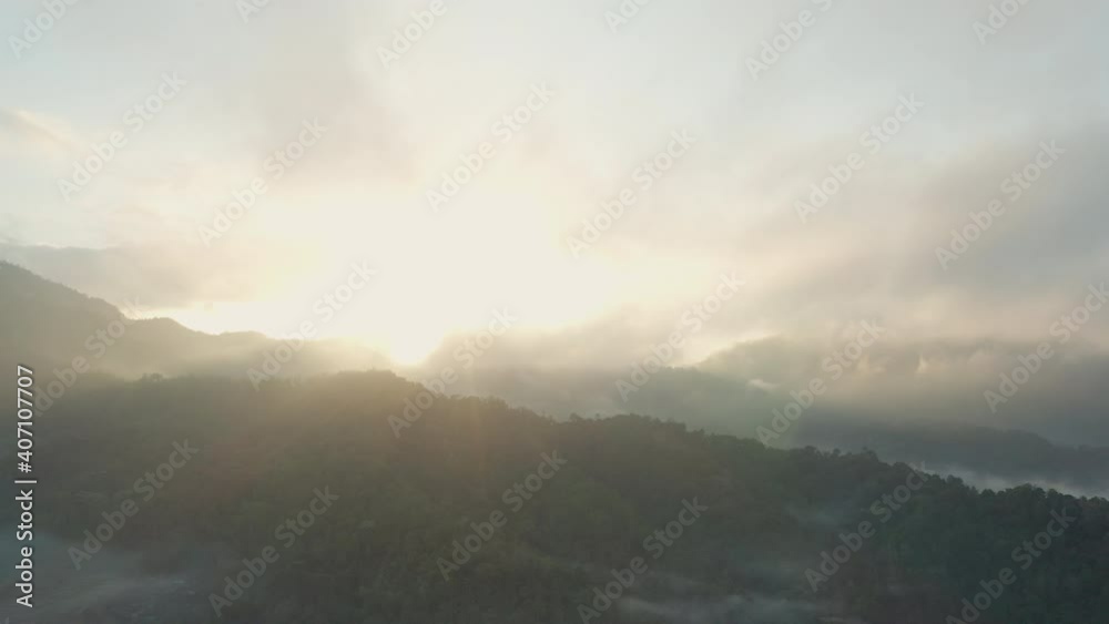 Drone Flight In Sunlit Sky Over Misty Landscape Drone Flight In Sunlit Sky Over Misty Landscape