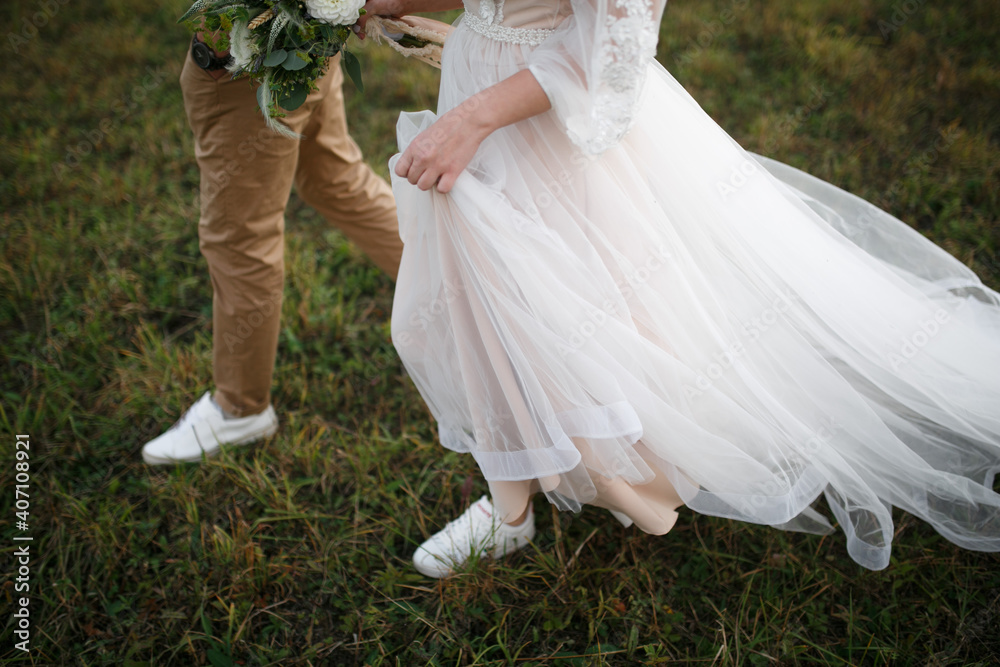 Fototapeta premium Legs of the bride and groom.