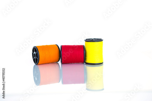 Colorful theread spool for sewing isolate on white background, textile equipment manufacture concept photo