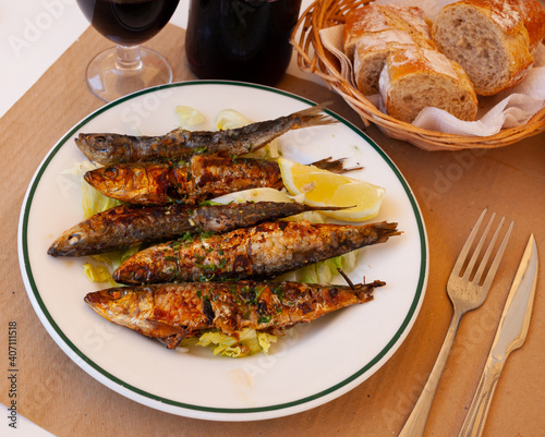 Portion of fried sardines served with lemon, typical dish of Spain